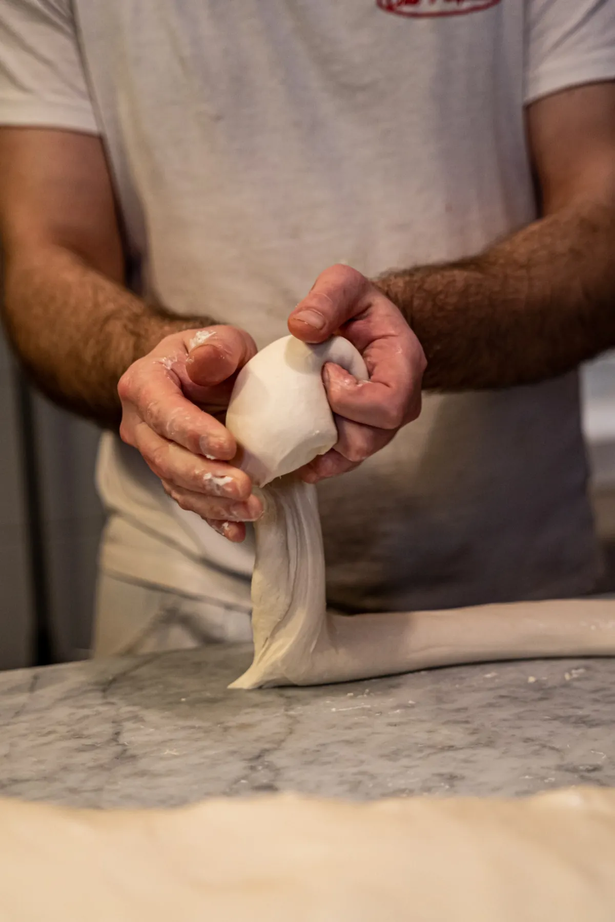 Lavorazione a mano dell'impasto della pizza